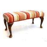 A footstool with cabriole legs upholstered in a striped fabric, 64cmW 30cmH