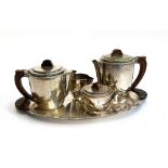 A stainless steel tea set and tray