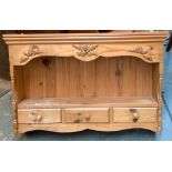A pine hanging wall unit with three drawers and acorn decoration. 94cmW