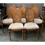 A good set of eight contemporary dining chairs, two carvers, with oval caned backs, and drop in