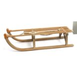 A beech children's sleigh, made by Gloco West Germany, 100cmL