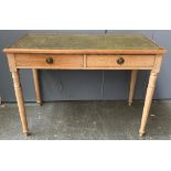 An early 20th century pine writing desk, with green leather skiver, two frieze drawers, on turned