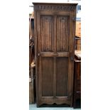 An early 20th century oak hanging cupboard, the door with linen fold carving, 68x41x175cmH (locked,