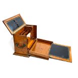 An oak writing box with fitted interior comprising letter rack, pen rest, inkwells etc