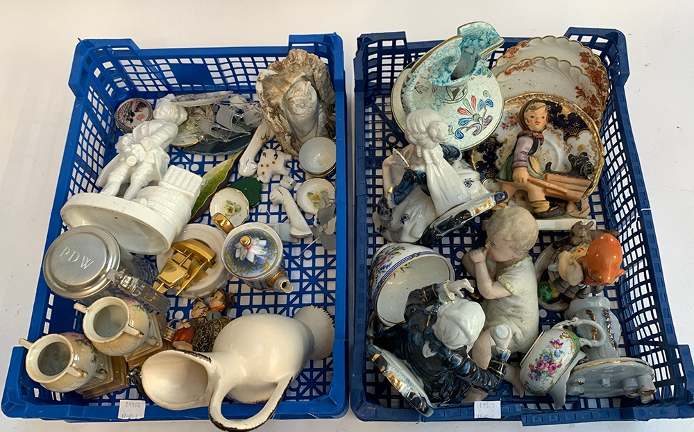 Two blue crates filled with mixed ceramics, mainly figurines