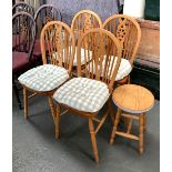 A set of four wheelback beech kitchen chairs, with squab cushions; together with a stool