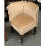 A 19th century upholstered corner chair on brass casters