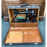 A vintage 99K Singer sewing machine, serial no. EK598051, in wooden carry case