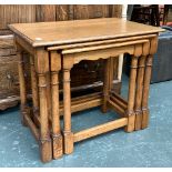 A Lloyd Loom corner laundry basket, bears label, 54cmH; together with a nest of three oak tables,