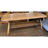 A mid century Ercol coffee table, with spindle turned undershelf, on splayed legs, 104x46x37cmH