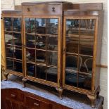 A walnut veneer three-part glazed bookshelf, with drawer above, on cabriole legs, 154cmW