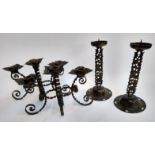 A pair of brass candlestick holders with pierced floral design, 33cmH; together with a pair of three