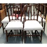 A set of five Regency dining chairs, one carver with stuffover seats and square tapered legs