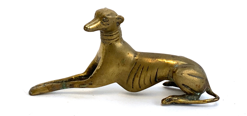 A brass figure of a recumbent greyhound, 9.5cmH