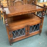 An oak side table/hostess trolley with undershelf and glazed doors, 83cmW