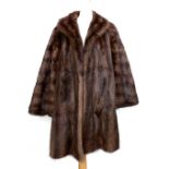 A John Dunn & Sons fur coat with shawl collar, size 10-12