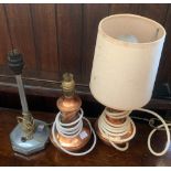 A pair of copper table lamps, each 24cm to top of fitting; together with one other