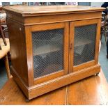 An oak glazed side cupboard, moulded top, the glazed door with wire grill, 73x47x63cmH