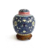 A 20th century Chinese enamelled ginger jar, character marks to base, approx. 18cmH; on a carved