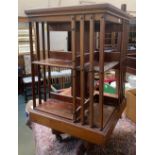 A mahogany rotating bookshelf, on casters, 50x50x86cmH