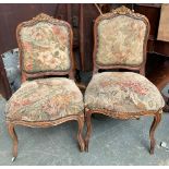 A near pair of continental carved occasional chairs, with upholstered seat and backs, acanthus