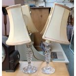 A pair of cut glass table lamps with half shades