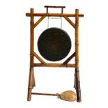 A British Army tiger bamboo dinner gong, 82cm high, the brass drum 32cm diameter
