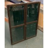 A green baize lined glazed notice board, 63x80cm