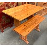 A pine kitchen table on refectory style base, 107x68x74cm; together with a matching bench, 106cmL