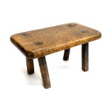An oak four legged rustic milking stool, 38cmW