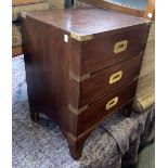 A mahogany campaign style cabinet of three drawers, brass corners and flush handles, 45x37x59cm