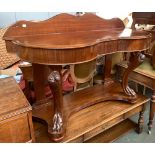A mahogany dressing table, shaped top with central drawer, on heavily carved cabriole paw feet,