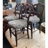 A set of four dining chairs with stuffover seats