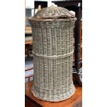 A cylindrical wicker lidded laundry basket, 63cmH