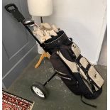 A set of Ben Sayers golf clubs, together with various others in a Mitsushiba bag; in a golf trolley