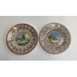 A pair of Victorian hand painted plates depicting a castle and a mill, each 20cmD, dated 1818