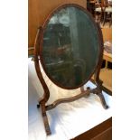 A 19th century oval adjustable dressing mirror, with original glass, 62cmH