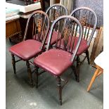 A set of four wheelback kitchen chairs with burgundy vinyl seats