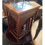 A nest of four hardwood Eastern carved tables, each with glass inset top over a carved scene in