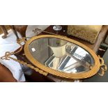 A giltwood oval wall mirror in the Adams taste, with bevelled glass, 70cmH