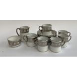 A T. Goode & Co. silvered part coffee set, comprising coffee cans (6) and saucers (7), milk jug
