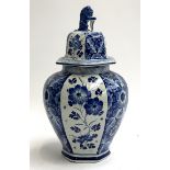 A large Delft urn with floral panel decoration and lion urn finial, date cipher BZ (1955), 43cmH