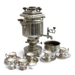 An eastern silver plated samavar, together with 6 chased silver plated coffee cups with ceramic