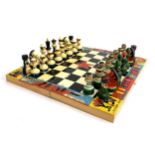 A hand painted Russian chess set, folding board 29cm square
