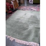 A green Chinese wool rug, 280x215cm
