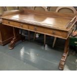 A light mahogany Edwardian writing desk, with three quarter gallery, moulded top, over two frieze dr