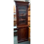 A narrow Victorian glazed cabinet bookcase, the top with glazed door flanked by acanthus