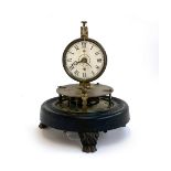 A late 19th/early 20th century brass perpetual motion clock with rotary spherical pendulum, the