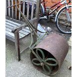 A large cast iron garden roller