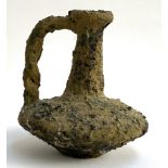 A clay bottle with twist handle, apparently recovered from a wreck, 19.5cmH
